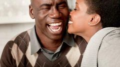 Young lady kissing older man