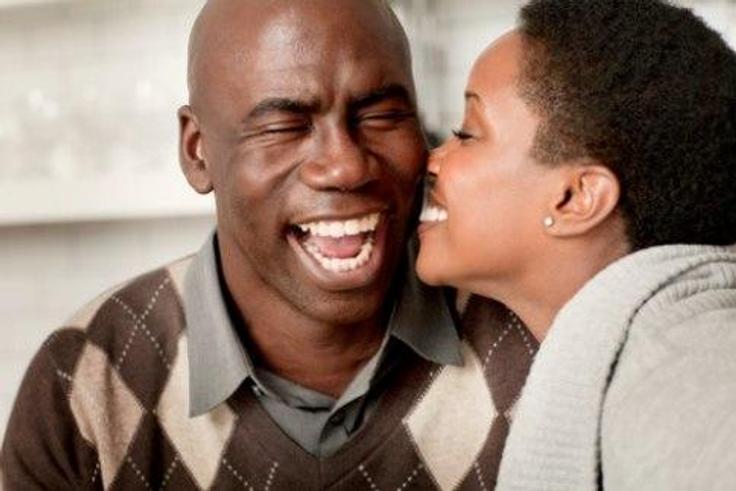 Young lady kissing older man
