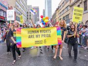 Amnesty International participants march with a banner saying, Human rights are my pride, during the Toronto LGBTQ Pride Parade.