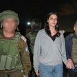 In this photo provided by the Government of Israel, Judith Raanan, right, and her 17-year-old daughter Natalie are escorted by Israeli soldiers and Gal Hirsch, Prime Minister Benjamin Netanyahu's special coordinator for returning the hostages, as they ...