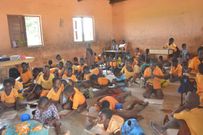 Pupils study on the bare floor