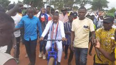 Joseph Dindiok Kpemka rides bicycle