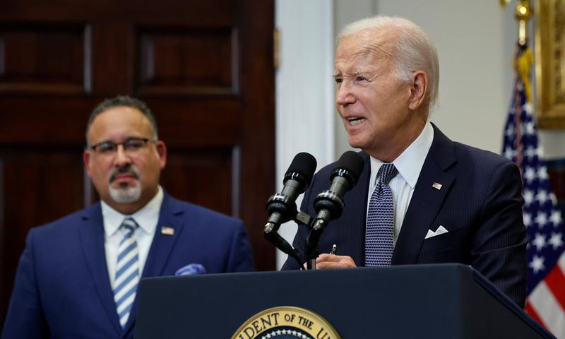 U.S. President Joe Biden is joined by Education Secretary Miguel Cardona (L).Chip Somodevilla/Getty Images