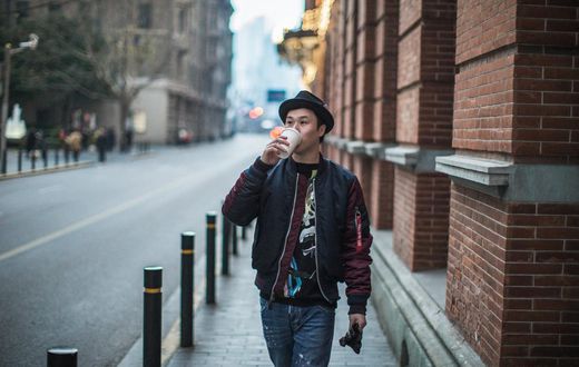 man walking and drinking coffee