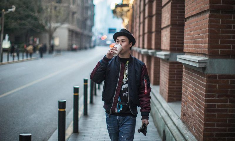 man walking and drinking coffee