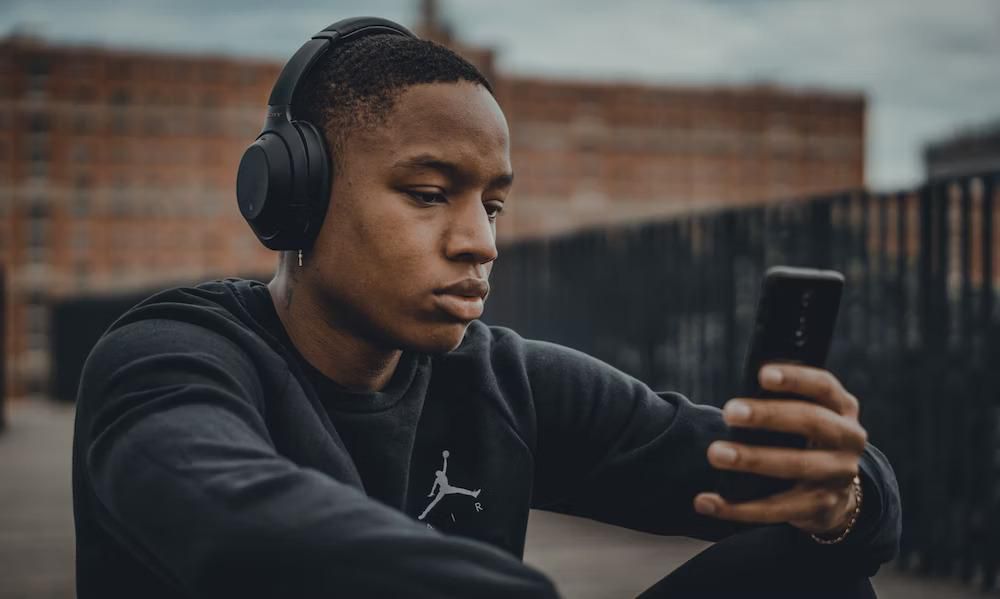 Stock photo of a Black man wearing headphones [Unsplash]