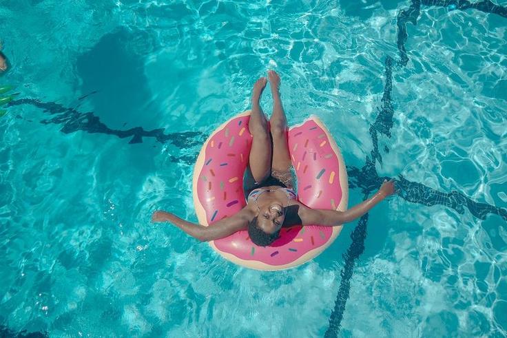 Woman on a pink swim ring [Photo: Kindel Media]
