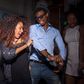Young man and woman dancing at house party - stock photo