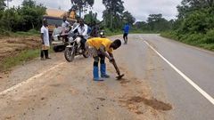 Illegal miners wash mud on road