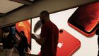 People stand in an Apple store in Manhattan.