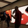 People stand in an Apple store in Manhattan.
