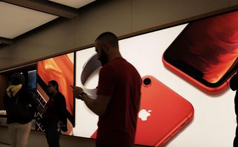 People stand in an Apple store in Manhattan.