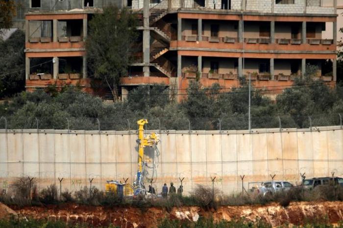 Israeli soldiers stand by machinery near the border wall with Lebanon on December 4, 2018 close to the northern Israeli town of Metula