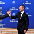 German Football Association (DFB) president Reinhard Grindel (L) is congratulated by UEFA president Aleksander Ceferin after it was announced that Germany will host Euro 2024