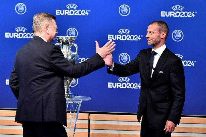 German Football Association (DFB) president Reinhard Grindel (L) is congratulated by UEFA president Aleksander Ceferin after it was announced that Germany will host Euro 2024
