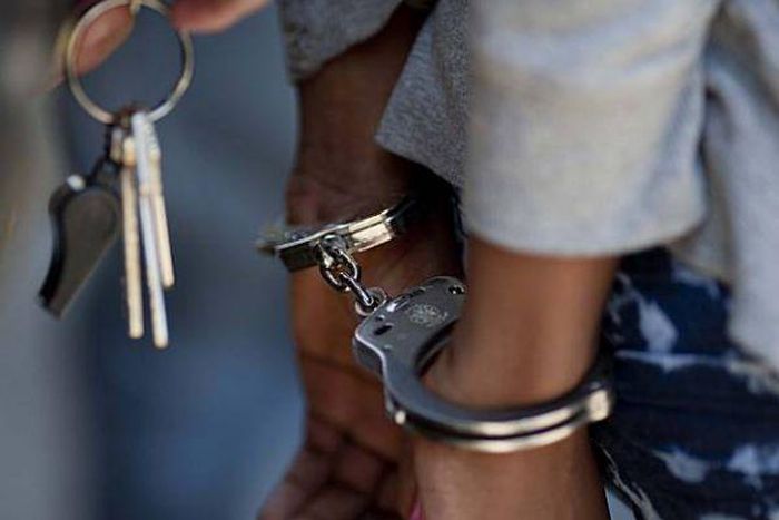 A woman in handcuffs