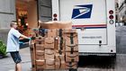 A US Postal worker delivers Amazon boxes outside of the New York Stock Exchange in October.