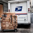 A US Postal worker delivers Amazon boxes outside of the New York Stock Exchange in October.