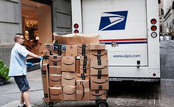 A US Postal worker delivers Amazon boxes outside of the New York Stock Exchange in October.