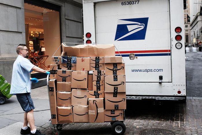 A US Postal worker delivers Amazon boxes outside of the New York Stock Exchange in October.
