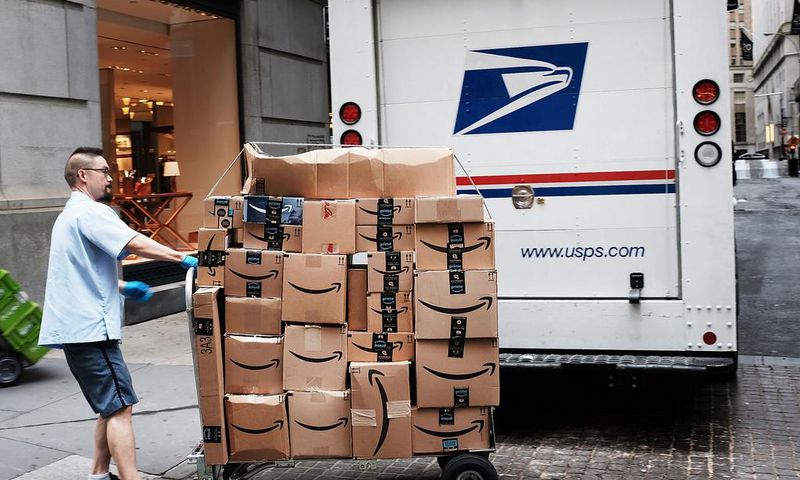 A US Postal worker delivers Amazon boxes outside of the New York Stock Exchange in October.