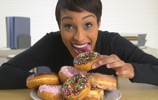Woman eating doughnut(shutterstock)