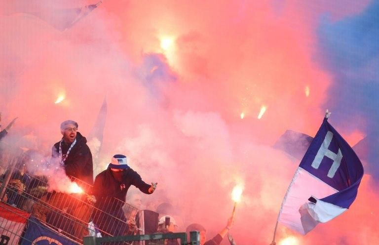 Hertha Berlin supporters burn flares during their teams Bundesliga match at Borussia Dortmund. Clashes with police resulted in 45 casualties and the German Football Association (DFB) have launched an investigation.