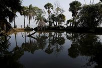 An island in India is disappearing, but some of the last residents say they can't afford to move away