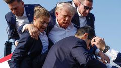 Donald Trump gets helped off the stage by aides in Pennsylvania on July 13 after an assassination attempt.Anna Moneymaker/Getty Images