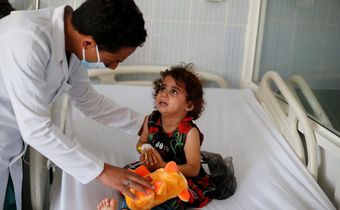 A nurse comforts a girl infected with diphtheria at the al-Sabeen hospital in Sanaa, Yemen October 21, 2018.