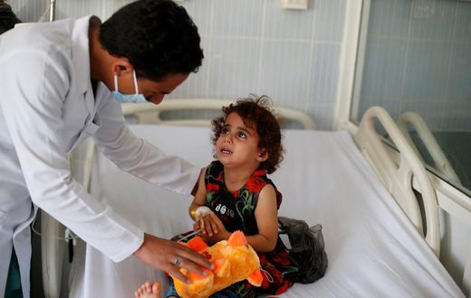 A nurse comforts a girl infected with diphtheria at the al-Sabeen hospital in Sanaa, Yemen October 21, 2018.