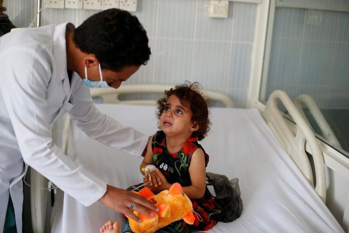A nurse comforts a girl infected with diphtheria at the al-Sabeen hospital in Sanaa, Yemen October 21, 2018.