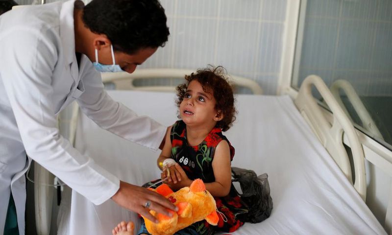 A nurse comforts a girl infected with diphtheria at the al-Sabeen hospital in Sanaa, Yemen October 21, 2018.