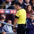 Spanish referee Sanchez Martinez checks the VAR screen before signaling a penalty kick against Real Madrid