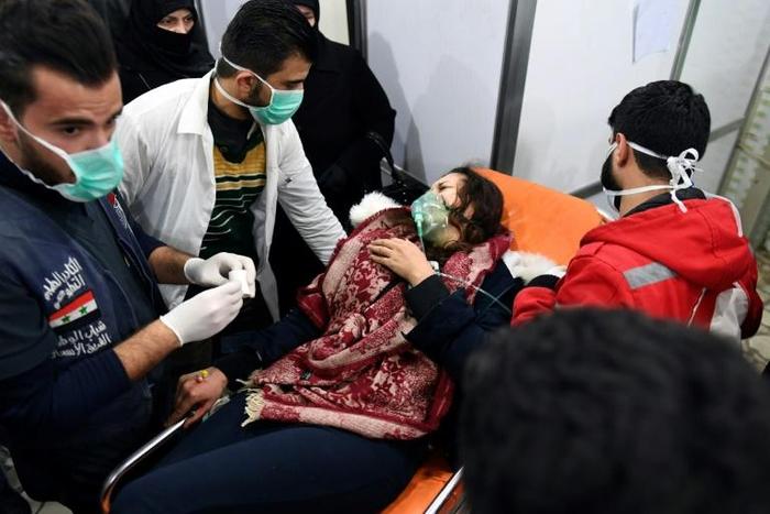 A Syrian woman receives treatment at a hospital after an assault on Aleppo, which Russia claimed was a chemical attack by rebels