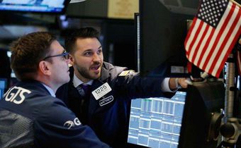 Traders work on the floor of the New York Stock Exchange ahead of the opening bell in New York, U.S., February 7, 2018. REUTERS/Brendan Mcdermid