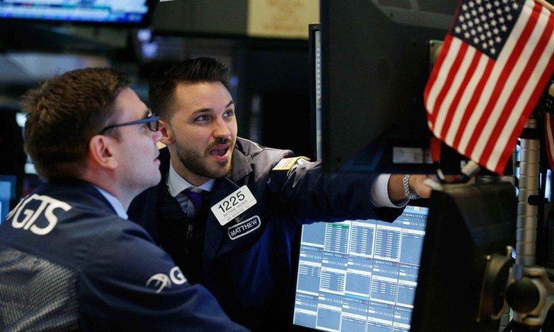 Traders work on the floor of the New York Stock Exchange ahead of the opening bell in New York, U.S., February 7, 2018. REUTERS/Brendan Mcdermid