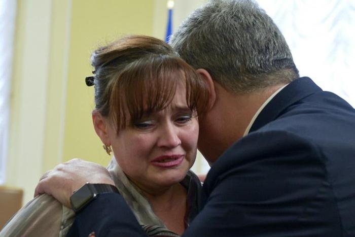 Ukrainian President Petro Poroshenko hugs a relative of one of the sailors arrested captured by Russia in one of the most dangerous incident between the two ex-Soviet neighbours in years