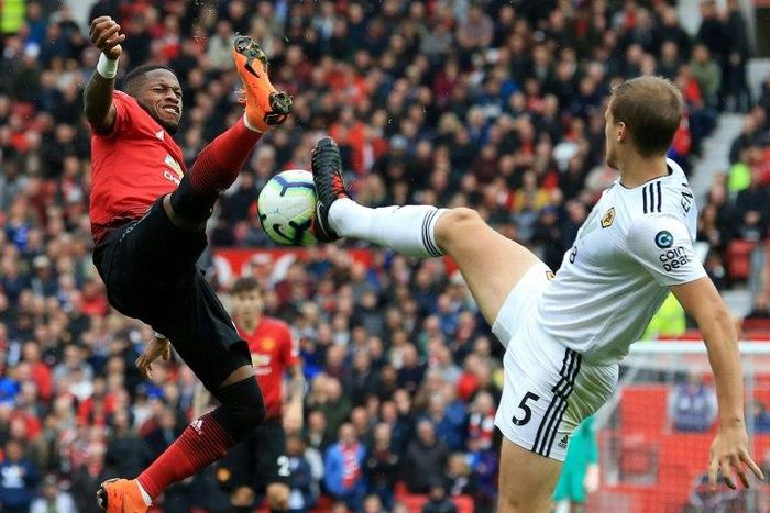 Manchester United midfielder Fred vies with Wolves defender Ryan Bennett
