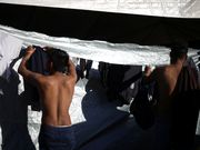 Powerful photos and stories from the caravan show migrants' harrowing journey to the US