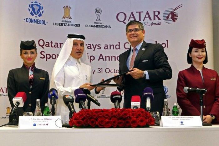 Chief Excecutive Officer (CEO) of Qatar Airways Akbar al-Baker (2nd L) and Jose Manuel Astigarraga, the secretary general of the South American football federation CONMEBOL, sign a sponsorship agreement in Doha on October 31, 2018