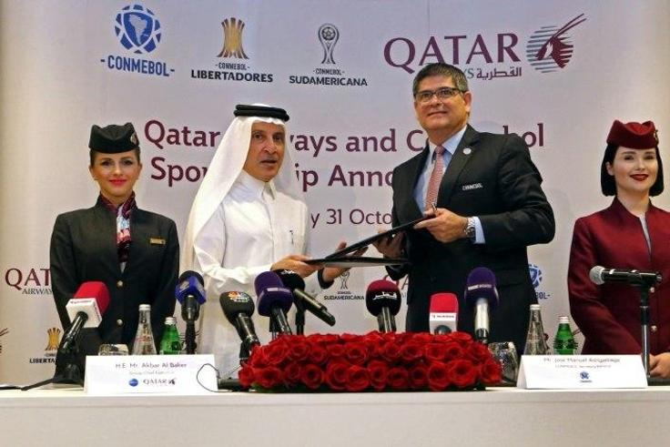 Chief Excecutive Officer (CEO) of Qatar Airways Akbar al-Baker (2nd L) and Jose Manuel Astigarraga, the secretary general of the South American football federation CONMEBOL, sign a sponsorship agreement in Doha on October 31, 2018