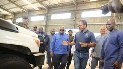 Mr-Kenneth-Akibate-middle-showing-some-of-the-assembled-vehicles-to-President-Akufo-Addo-on-tour-of-the-facility