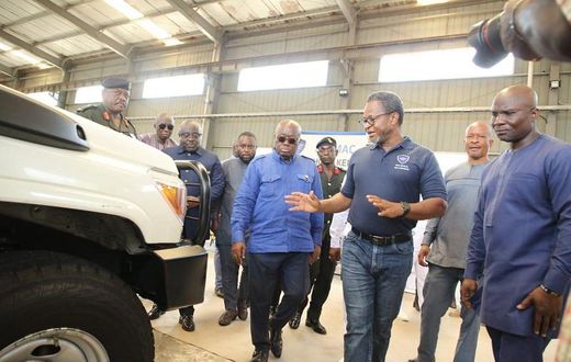 Mr-Kenneth-Akibate-middle-showing-some-of-the-assembled-vehicles-to-President-Akufo-Addo-on-tour-of-the-facility