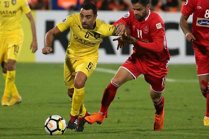 Spain great Xavi Hernandez (L), touted as a potential future manager of Qatar, believes the 2022 World Cup hosts can make progress on the international scene.