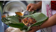 Waakye seller serving the food