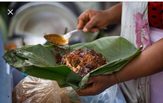 Waakye seller serving the food