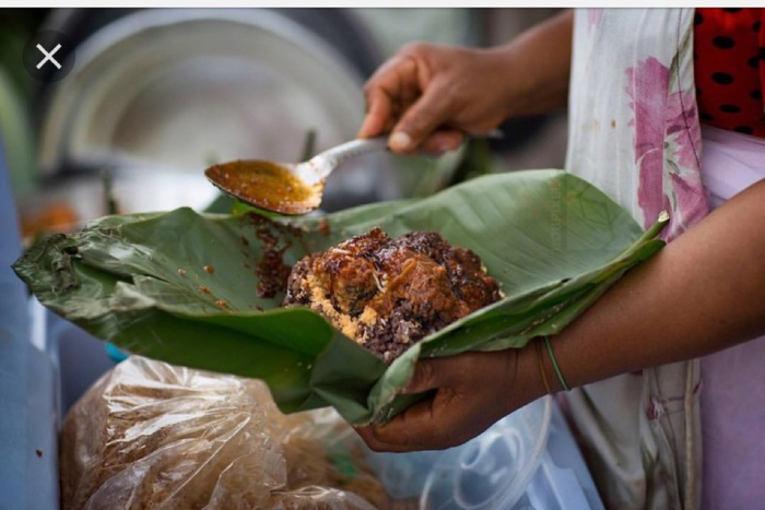 Waakye seller serving the food