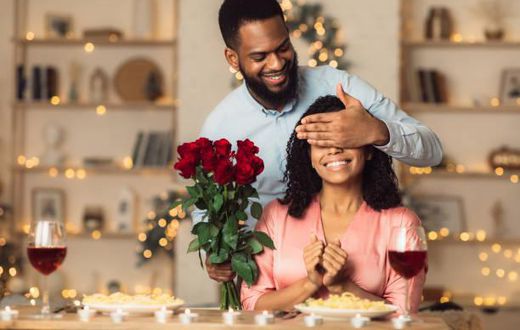 A romantic man giving her woman a flower