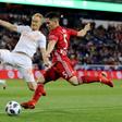 Connor Lade (R) of New York Red Bulls takes a shot as Jeff Larentowicz of Atlanta United defends in the first half during the Eastern Conference Finals Leg 2 match, at Red Bull Arena in Harrison, New Jersey, on November 29, 2018